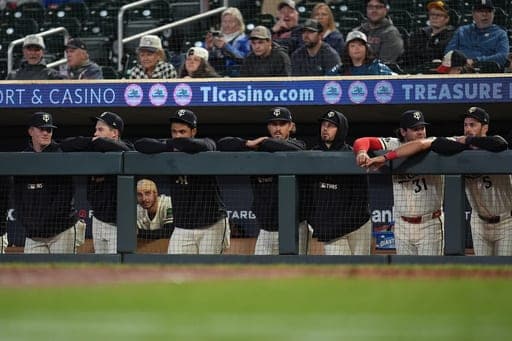 Minnesota Twins pitcher Joe Ryan, center, and teammates look on during the ninth inning of a baseball game against the Texas Rangers, Saturday, Sept. 26, 2026, in Minneapolis. (AP Photo/Abbie Parr) (AP Photo/Abbie Parr)
