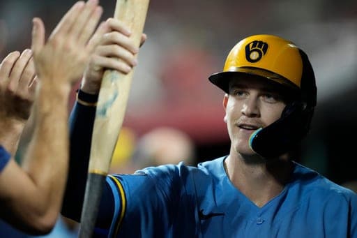 Milwaukee Brewers Cooper Pratt celebrate in the dugout after scoring on a wild pitch by Cincinnati Reds pitcher Sam Moll the fifth inning of a baseball game on Friday, Sept. 4, 2026, in Cincinnati. (AP Photo/Carolyn Kaster) (AP Photo/Carolyn Kaster)