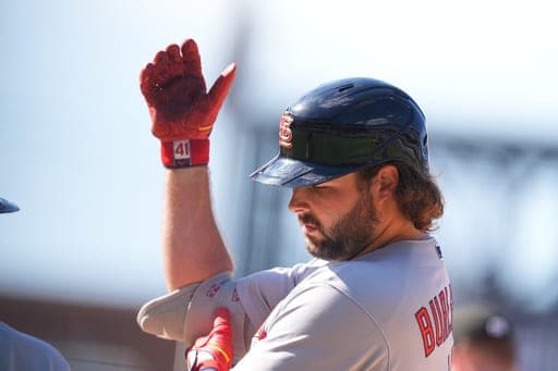 St. Louis Cardinals' Alec Burleson gestures to the dugout after reaching first base on an RBI single off Colorado Rockies relief pitcher Nick Frasso in the eighth inning of a baseball game Sunday, Sept. 6, 2026, in Denver. (AP Photo/David Zalubowski) (AP Photo/David Zalubowski)