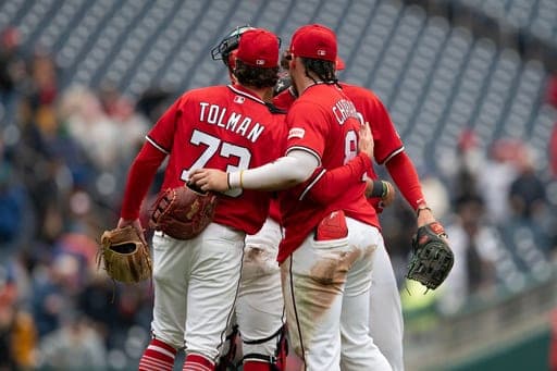 Washington Nationals relief pitcher Erik Tolman, left, and ndrés Chaparro, right, celebrate with teammates after a baseball game against the New York Mets, Sunday, Sept. 27, 2026, in Washington. (AP Photo/Jose Luis Magana) (AP Photo/Jose Luis Magana)