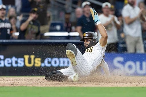 San Diego Padres' Fernando Tatis Jr. scores on Jake Cronenworth's two-RBI double in the seventh inning of a baseball game against the Minnesota Twins, Saturday, Aug. 22, 2026, in San Diego. (AP Photo/Karl Anderson) (AP Photo/Karl Anderson)