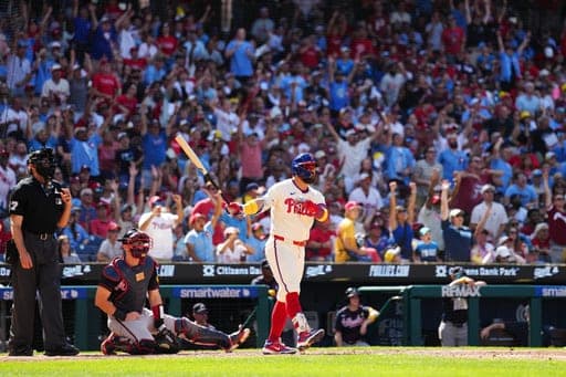 Philadelphia Phillies' Kyle Schwarber, right, watches his solo home run off Atlanta Braves pitcher Dylan Dodd during the seventh inning of a baseball game, Sunday, Sept. 6, 2026, in Philadelphia. (AP Photo/Derik Hamilton) (AP Photo/Derik Hamilton)