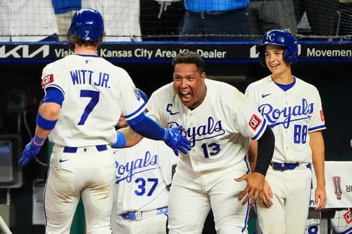 Kansas City Royals' Bobby Witt Jr. (7) celebrates with Salvador Perez (13) after scoring on a three-run double by John Rave during the eighth inning of a baseball game against the Athletics, Wednesday, Aug. 19, 2026, in Kansas City, Mo. (AP Photo/Charlie Riedel) (AP Photo/Charlie Riedel)