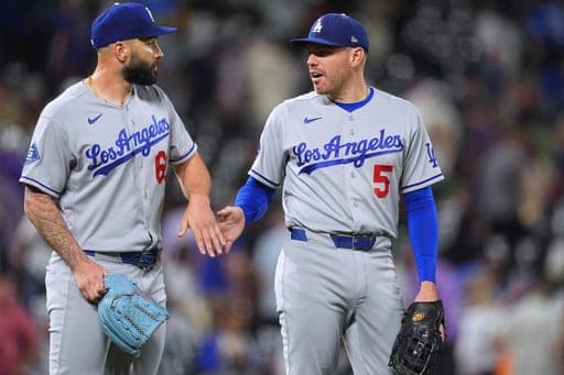 Los Angeles Dodgers first baseman Freddie Freeman, right, congratulates relief pitcher Tanner Scott after defeating the Colorado Rockies in a baseball game Wednesday, Aug. 19, 2026, in Denver. (AP Photo/David Zalubowski) (AP Photo/David Zalubowski)