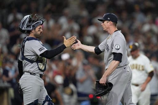 New York Yankees pitcher Tim Hill, right, celebrates with catcher Austin Wells after the Yankees defeated the San Diego Padres 5-1 in a baseball game Saturday, Sept. 5, 2026, in San Diego. (AP Photo/Gregory Bull) (AP Photo/Gregory Bull)