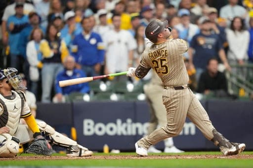 San Diego Padres' Ty France hits a ball that hit a cable near the roof during the ninth inning of Game 1 of a National League Divisional baseball playoff series against the Milwaukee Brewers Sunday, Oct. 4, 2026, in Milwaukee. (AP Photo/Kayla Wolf) (AP Photo/Kayla Wolf)