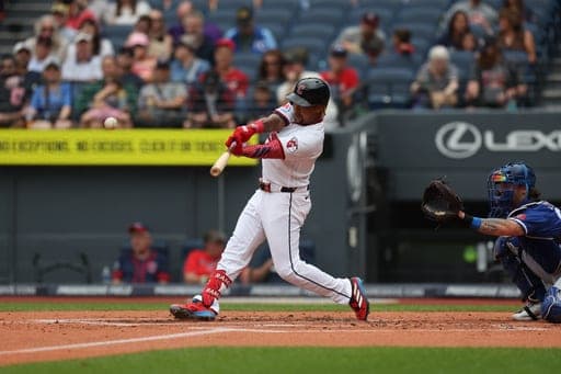 Cleveland Guardians' José Ramírez, left, hits a sacrifice fly against the Kansas City Royals in the first inning of a baseball game in Cleveland, Sunday, Aug. 30, 2026. (AP Photo/Tim Phillis) (AP Photo/Tim Phillis)