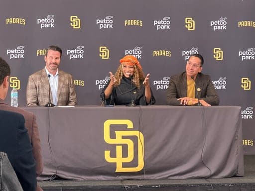 New San Diego Padres owners Kwanza Jones, center, and José E. Feliciano, right, speak at a news conference with team CEO Erik Greupner, left, at Petco Park in San Diego, Calif., Monday, Aug. 24, 2026. (AP Photo/Greg Beacham) (AP Photo/Greg Beacham)