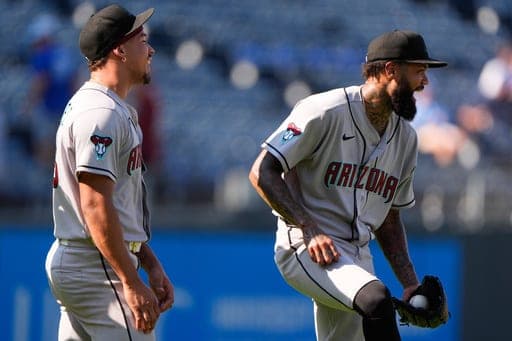 Arizona Diamondbacks' Justin Martinez, left, and Dennis Santana celebrate after their baseball game against the Kansas City Royals, Monday, Sept. 7, 2026, in Kansas City, Mo. (AP Photo/Charlie Riedel) (AP Photo/Charlie Riedel)