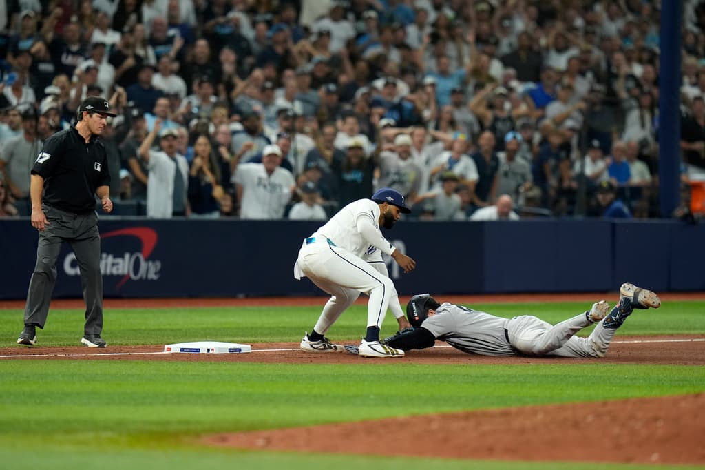 Rays third baseman Junior Caminero tags out Austin Wells at third base in Game 1 of the American League Division Series.