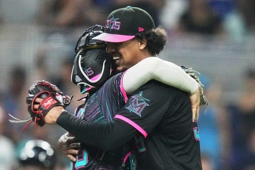 Miami Marlins starting pitcher Eury Pérez, right, hugs catcher Joe Mack, left, after pitching a complete game shutout in a baseball game against the Atlanta Braves, Friday, Sept. 25, 2026, in Miami. (AP Photo/Lynne Sladky) (AP Photo/Lynne Sladky)