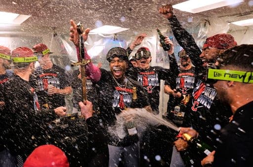 Cleveland Guardians' Angel Martínez, center, celebrates with teammates after clinching a postseason playoff spot following a baseball game against the Boston Red Sox, Thursday, Sept. 24, 2026, in Boston. (AP Photo/Charles Krupa) (AP Photo/Charles Krupa)