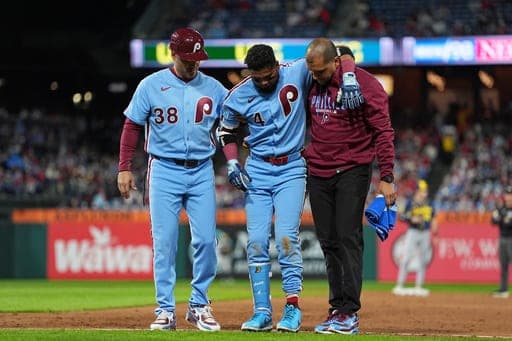 Philadelphia Phillies' Luis Arraez (4) is helped off the field after being injured during the sixth inning of a baseball game against the Milwaukee Brewers, Thursday, Sept. 24, 2026, in Philadelphia. (AP Photo/Matt Rourke) (AP Photo/Matt Rourke)