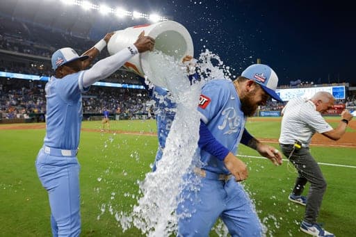 Kansas City Royals' Kyle Isbel, second from right, is doused by Tyler Tolbert, left, and another teammate at the end of a baseball game against the Detroit Tigers in Kansas City, Mo., Saturday, Aug. 22, 2026. (AP Photo/Colin E. Braley) (AP Photo/Colin E. Braley)