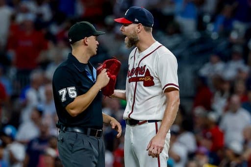 Atlanta Braves pitcher Chris Sale, right, speaks with umpire Edwin Jimenez (75) during a replay review in the ninth inning of a baseball game against the Los Angeles Dodgers, Thursday, Aug. 27, 2026, in Atlanta. (AP Photo/Erik S. Lesser) (AP Photo/Erik S. Lesser)