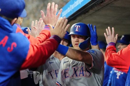 Texas Rangers' Josh Jung celebrates in the dugout after scoring during the first inning of a baseball game against the Minnesota Twins, Friday, Sept. 25, 2026, in Minneapolis. (AP Photo/Ellen Schmidt) (AP Photo/Ellen Schmidt)