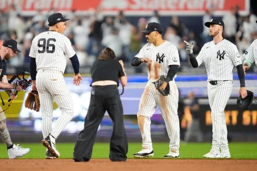 From left, New York Yankees shortstop George Lombard Jr. (96), center fielder Trent Grisham and left fielder Cody Bellinger celebrate a win over the Boston Red Sox within Game 2 of baseball's American League Wild Card Series, Wednesday, Sept. 30, 2026, in New York. (AP Photo/Yuki Iwamura) (AP Photo/Yuki Iwamura)