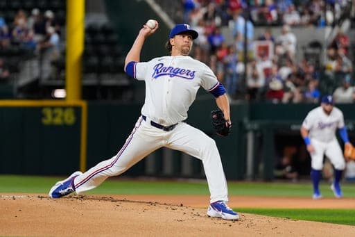 Texas Rangers pitcher Jacob deGrom throws and strikes out Washington Nationals' Abimelec Ortiz, deGrom's 2000th career strikeout, in the first inning of a baseball game Thursday, Aug. 20, 2026, in Arlington, Texas. (AP Photo/Tony Gutierrez) (AP Photo/Tony Gutierrez)