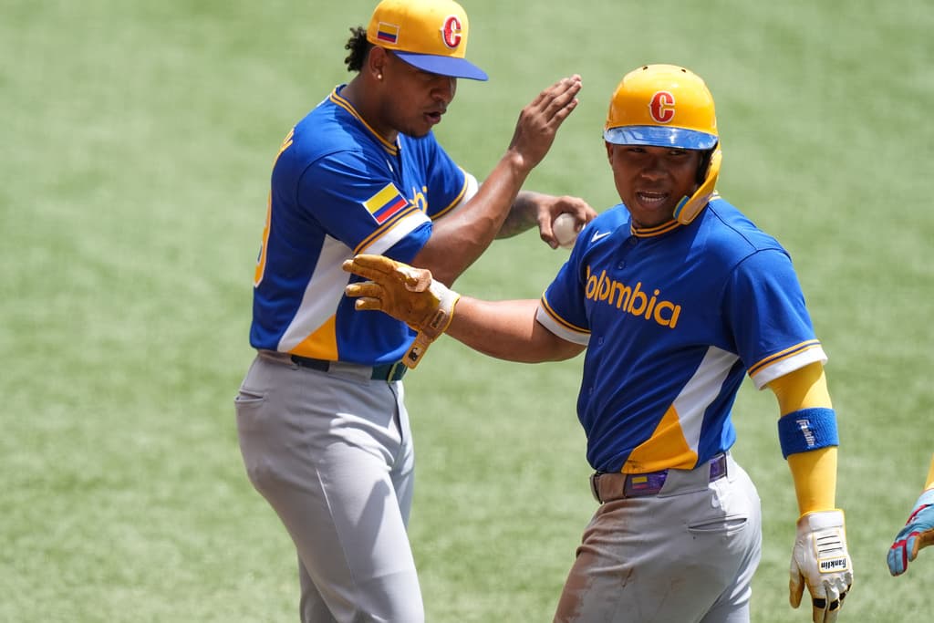 Colombia's Michael Arroyo celebrates after scoring against Cuba during the first inning of WBC Game, and today he debut for Seattle Mariners