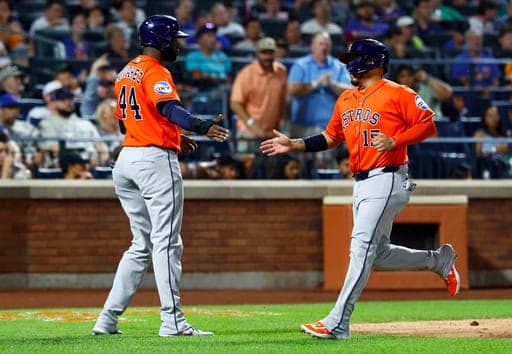 Houston Astros Yordan Alvarez (44) and Isaac Paredes shake hands after scoring against the New York Mets during the sixth inning of a baseball game, Friday, August 28, 2026, in New York. (AP Photo/Noah K. Murray) (AP Photo/Noah K. Murray)