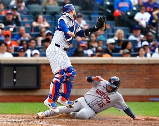 Houston Astros' Isaac Paredes (15) scores a run under New York Mets catcher Luis Torrens during the seventh inning of a baseball game, Sunday, Aug. 30, 2026, in New York. (AP Photo/Noah K. Murray) (AP Photo/Noah K. Murray)