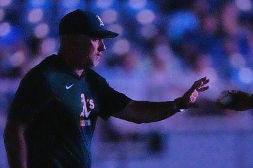 Athletics manager Mark Kotsay walks to the mound to make a pitching change during the eighth inning of a baseball game against the Kansas City Royals, Tuesday, Aug. 18, 2026, in Kansas City, Mo. (AP Photo/Charlie Riedel) (AP Photo/Charlie Riedel)
