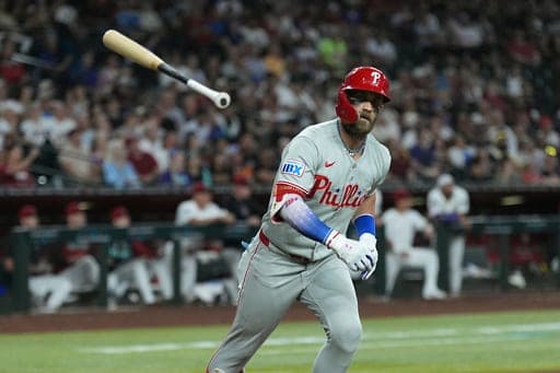 Philadelphia Phillies' Bryce Harper tosses his bat after flying out against the Arizona Diamondbacks during the fifth inning of a baseball game, Monday, Aug. 31, 2026, in Phoenix. (AP Photo/Ross D. Franklin) (AP Photo/Ross D. Franklin)