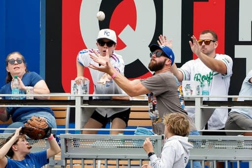 A fan attempts to catch a three-run home run hit by Detroit Tigers' Kevin McGonigle during the fifth inning of a baseball game against the Kansas City Royals in Kansas City, Mo., Sunday, Aug. 23, 2026. (AP Photo/Colin E. Braley) (AP Photo/Colin E. Braley)