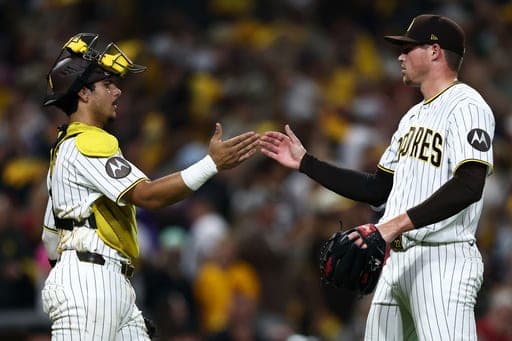 San Diego Padres pitcher Mason Miller, right, and catcher Ethan Salas, left, celebrate after their team won a baseball game against the Arizona Diamondbacks, Saturday, Sept. 26, 2026, in San Diego. (AP Photo/Karl Anderson) (AP Photo/Karl Anderson)