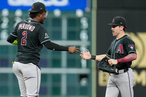 Arizona Diamondbacks' Geraldo Perdomo (2) and Corbin Carroll celebrates the team's win over the Houston Astros in a baseball game Saturday, Sept. 5, 2026, in Houston. (AP Photo/Eric Christian Smith) (AP Photo/Eric Christian Smith)