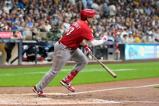 Reds on cusp of playoff berth after beating Brewers 7-4