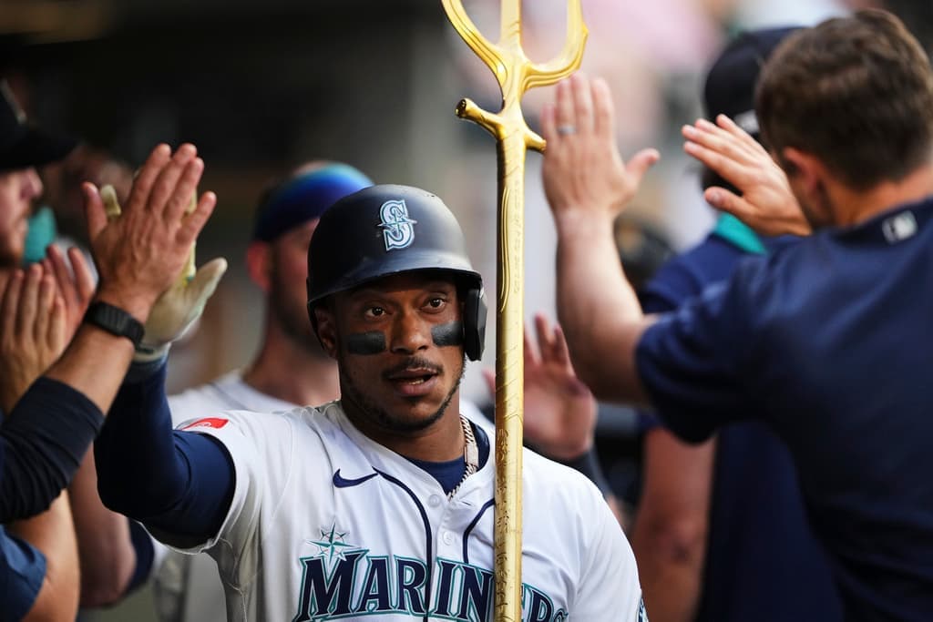 Title: Padres Mariners Baseball Image ID: 25238096352620 Article: Seattle Mariners' Jorge Polanco holds the trident in the dugout after hitting a two-run home run against the San Diego Padres during the second inning of a baseball game Monday, Aug. 25, 2025, in Seattle. (AP Photo/Lindsey Wasson)