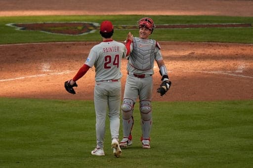 Philadelphia Phillies pitcher Andrew Painter (24) celebrates with catcher J.T. Realmuto after the final out in the 10th inning during Game 2 of baseball's National League Wild Card Series Wednesday, Sept. 30, 2026, in Atlanta. (AP Photo/Mike Stewart) (AP Photo/Mike Stewart)