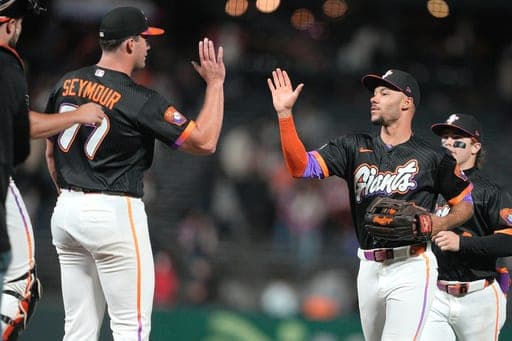 San Francisco Giants pitcher Carson Seymour, left, celebrates with Grant McCray, right, after their team's victory against the Cincinnati Reds during a baseball game Tuesday, Aug. 25, 2026, in San Francisco. (AP Photo/Tony Avelar) (AP Photo/Tony Avelar)