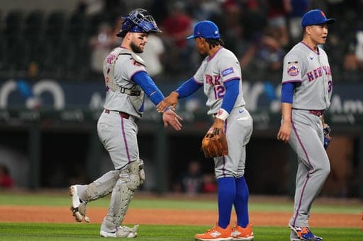 New York Mets' Luis Torrens, left, Francisco Lindor (12) and Kodai Senga, right, celebrate the team's win in a baseball game against the Texas Rangers Tuesday, Sept. 22, 2026, in Arlington, Texas. (AP Photo/Tony Gutierrez) (AP Photo/Tony Gutierrez)