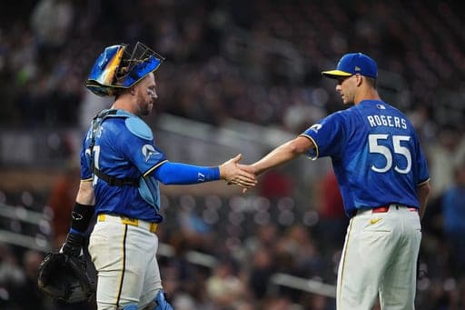 Minnesota Twins pitcher Taylor Rogers (55) and catcher Ryan Jeffers, left, celebrate after a baseball game against the Texas Rangers, Friday, Sept. 25, 2026, in Minneapolis. (AP Photo/Ellen Schmidt) (AP Photo/Ellen Schmidt)