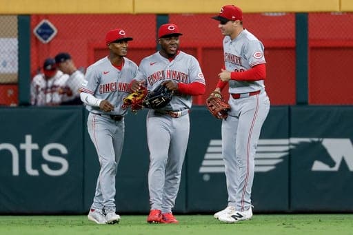 Cincinnati Reds outfielders Carlos Jorge, left, Héctor Rodríguez, center, and JJ Bleday, right, celebrate after their team defeated the Atlanta Braves in a baseball game, Thursday, Sept. 24, 2026, in Atlanta. (AP Photo/Erik S. Lesser) (AP Photo/Erik S. Lesser)