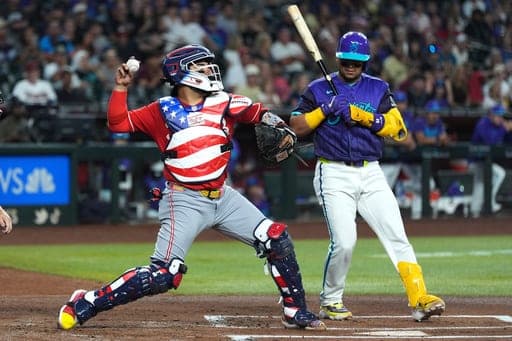 Cincinnati Reds catcher Jose Trevino, left, throws to second base as Arizona Diamondbacks' Gabriel Moreno looks on during the first inning of a baseball game, Friday, Aug. 21, 2026, in Phoenix. (AP Photo/Ross D. Franklin) (AP Photo/Ross D. Franklin)
