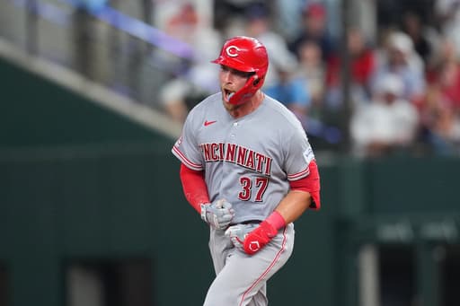 Reds beat Rangers 5-3 in their 1st road game with 3 homers, the last in the 9th