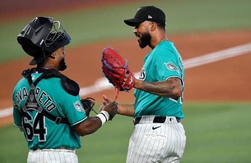 Miami Marlins Sandy Alcantara, right, celebrates beating the Atlanta Braves with catcher Brian Navarreto after the ninth inning of a baseball game, Sunday, Sept. 27, 2026, in Miami. (AP Photo/Michael Laughlin) (AP Photo/Michael Laughlin)