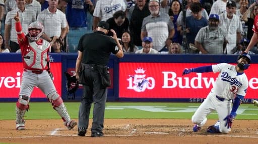 Cincinnati Reds catcher Jose Trevino, left, celebrates after tagging out Los Angeles Dodgers' Teoscar Hernández as Hernández tried to score on an inside-the-park home run during the third inning of a baseball game Tuesday, Sept. 8, 2026, in Los Angeles. (AP Photo/Mark J. Terrill) (AP Photo/Mark J. Terrill)