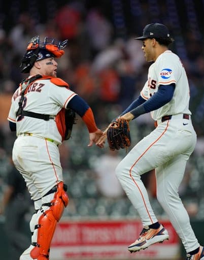 Houston Astros' Christian Vázquez (2) and Cam Smith celebrate after a baseball game against the Los Angeles Angels Wednesday, Aug. 19, 2026, in Houston. (AP Photo/David J. Phillip) (AP Photo/David J. Phillip)