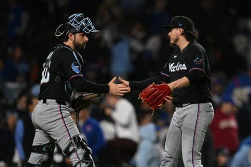 Miami Marlins closing pitcher Victor Vodnik, right, celebrates with catcher Joe Mack, left, after defeating the Chicago Cubs in the twelfth inning of a baseball game Tuesday, Sept. 22, 2026, in Chicago. (AP Photo/Paul Beaty) (AP Photo/Paul Beaty)