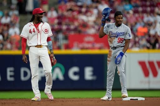 Cincinnati Reds shortstop Elly De La Cruz (44), looks to Los Angeles Dodgers' Josue de Paula (95), after Josue de Paula stole second during the fifth inning of a baseball game, Monday, Sept. 14, 2026, in Cincinnati. (AP Photo/Carolyn Kaster) (AP Photo/Carolyn Kaster)
