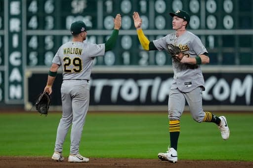 Athletics second baseman Donovan Walton (29) and center fielder Henry Bolte, right, celebrate after a baseball game against the Houston Astros, Saturday, Aug. 22, 2026, in Houston. (AP Photo/Kevin M. Cox) (AP Photo/Kevin M. Cox)