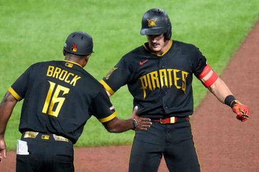 Pittsburgh Pirates' Konnor Griffin, right, celebrates with first base coach Tarrik Brock (16) after driving in a run with a single off Kansas City Royals pitcher Nate Pearson during the seventh inning of a baseball game in Pittsburgh, Friday, Sept. 18, 2026. (AP Photo/Gene J. Puskar) (AP Photo/Gene J. Puskar)