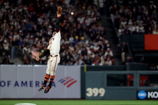 San Francisco Giants' Christian Koss leaps for a single hit by Arizona Diamondbacks Max Kepler during the ninth inning of a baseball game in San Francisco, Thursday, Aug. 27, 2026. (AP Photo/Jed Jacobsohn) (AP Photo/Jed Jacobsohn)