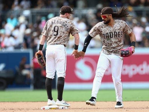 San Diego Padres third baseman Jake Cronenworth, left, and second baseman Fernando Tatis Jr., right, celebrate after defeating the Miami Marlins in a baseball game Sunday, Sept. 20, 2026, in San Diego. (AP Photo/Karl Anderson) (AP Photo/Karl Anderson)