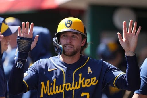 Milwaukee Brewers' Brice Turang is congratulated in the dugout after scoring in the eighth inning of a baseball game against the Cincinnati Reds, Sunday, Sept. 6, 2026, in Cincinnati. (AP Photo/Kareem Elgazzar) (AP Photo/Kareem Elgazzar)