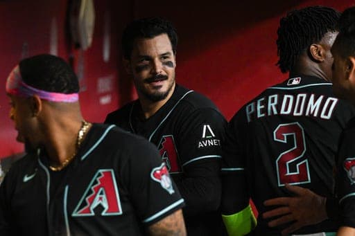 Arizona Diamondbacks' Nolan Arenado, center, looks on in the dugout after hitting a grand slam in the fifth inning of a baseball game against the New York Yankees, Sunday, Sept. 20, 2026, in Phoenix. (AP Photo/Caitlin O'Hara) (AP Photo/Caitlin O'Hara)